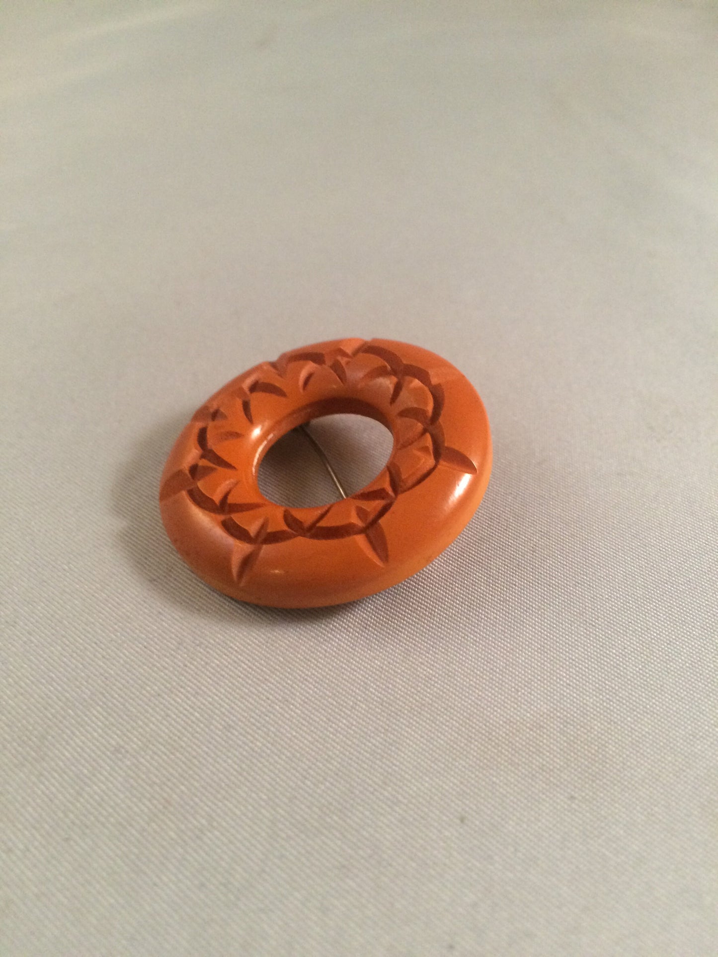 Bakelite Catalin Orange Carved Circle Brooch