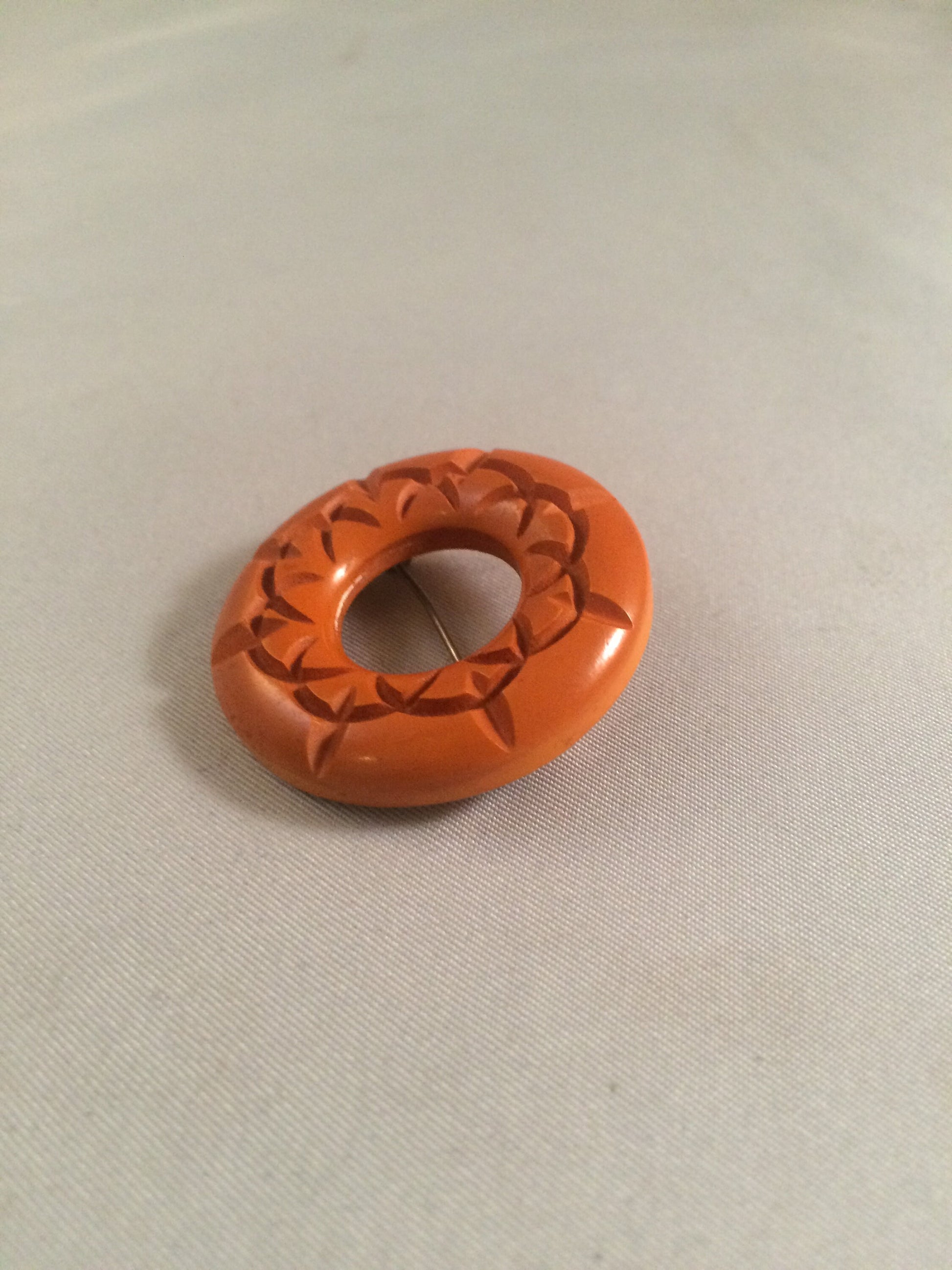 Bakelite Catalin Orange Carved Circle Brooch