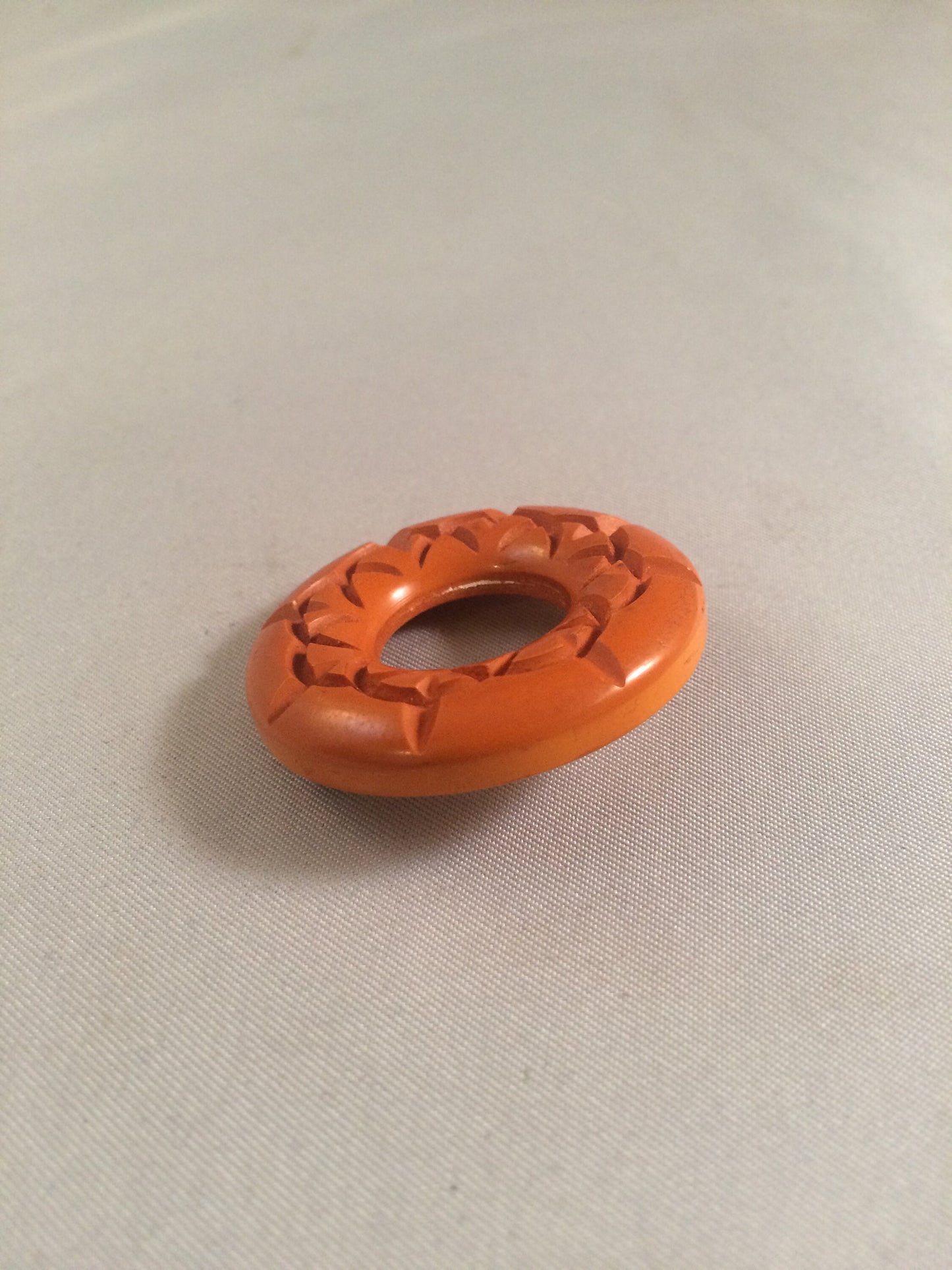Bakelite Catalin Orange Carved Circle Brooch