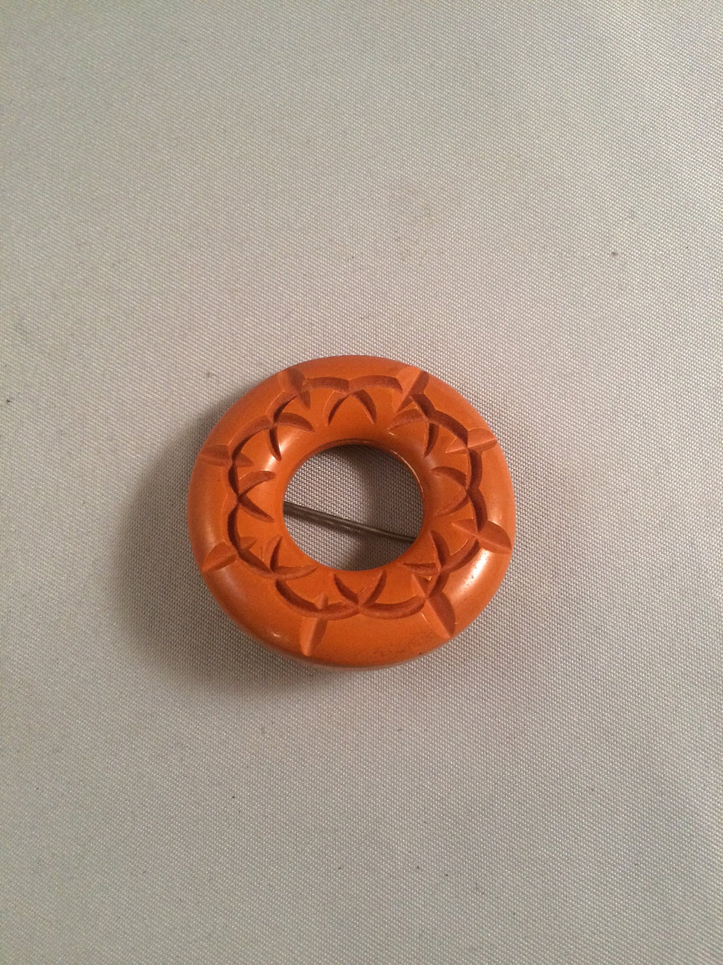 Bakelite Catalin Orange Carved Circle Brooch