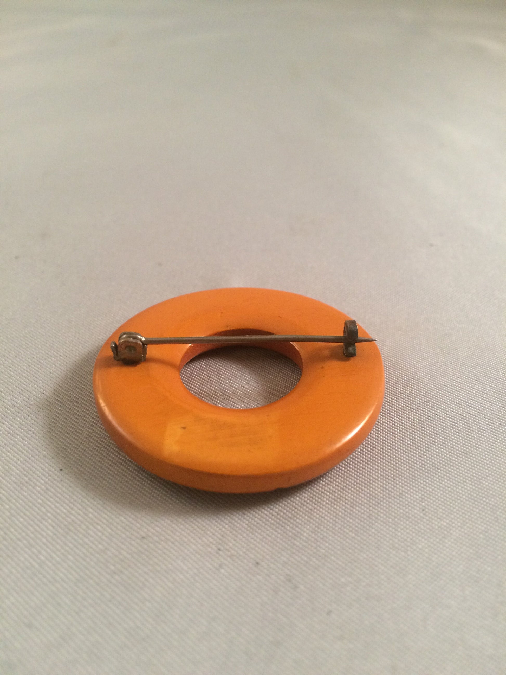 Bakelite Catalin Orange Carved Circle Brooch