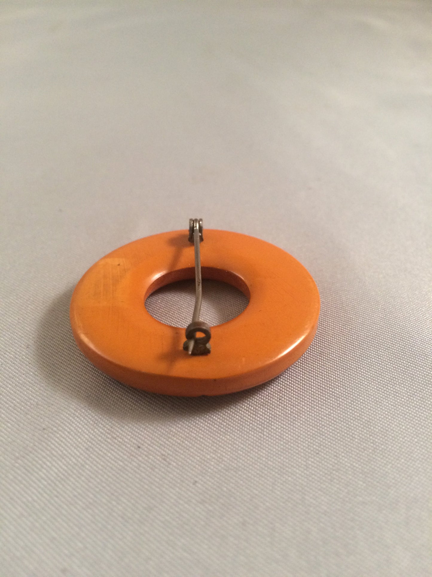 Bakelite Catalin Orange Carved Circle Brooch