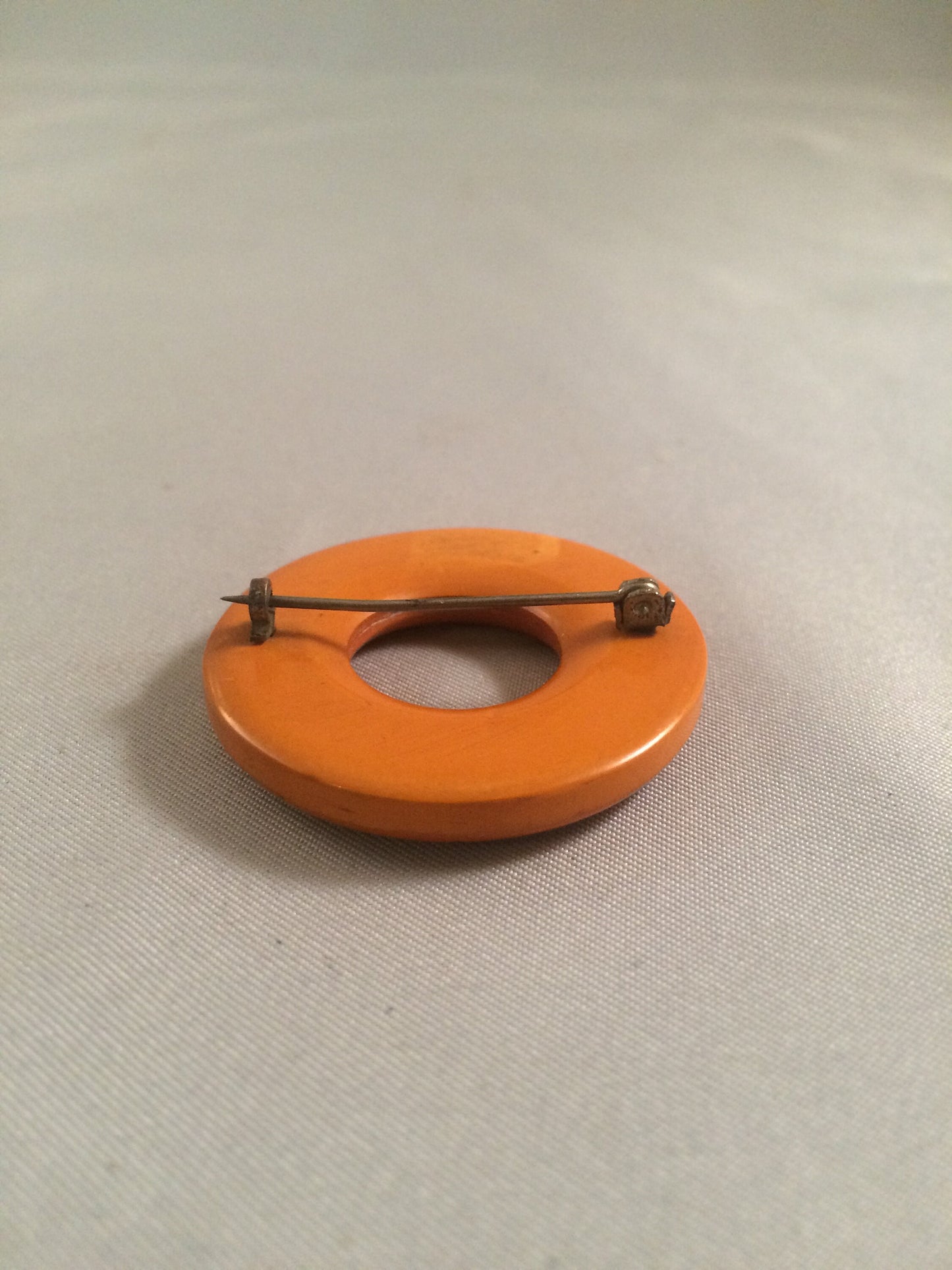 Bakelite Catalin Orange Carved Circle Brooch