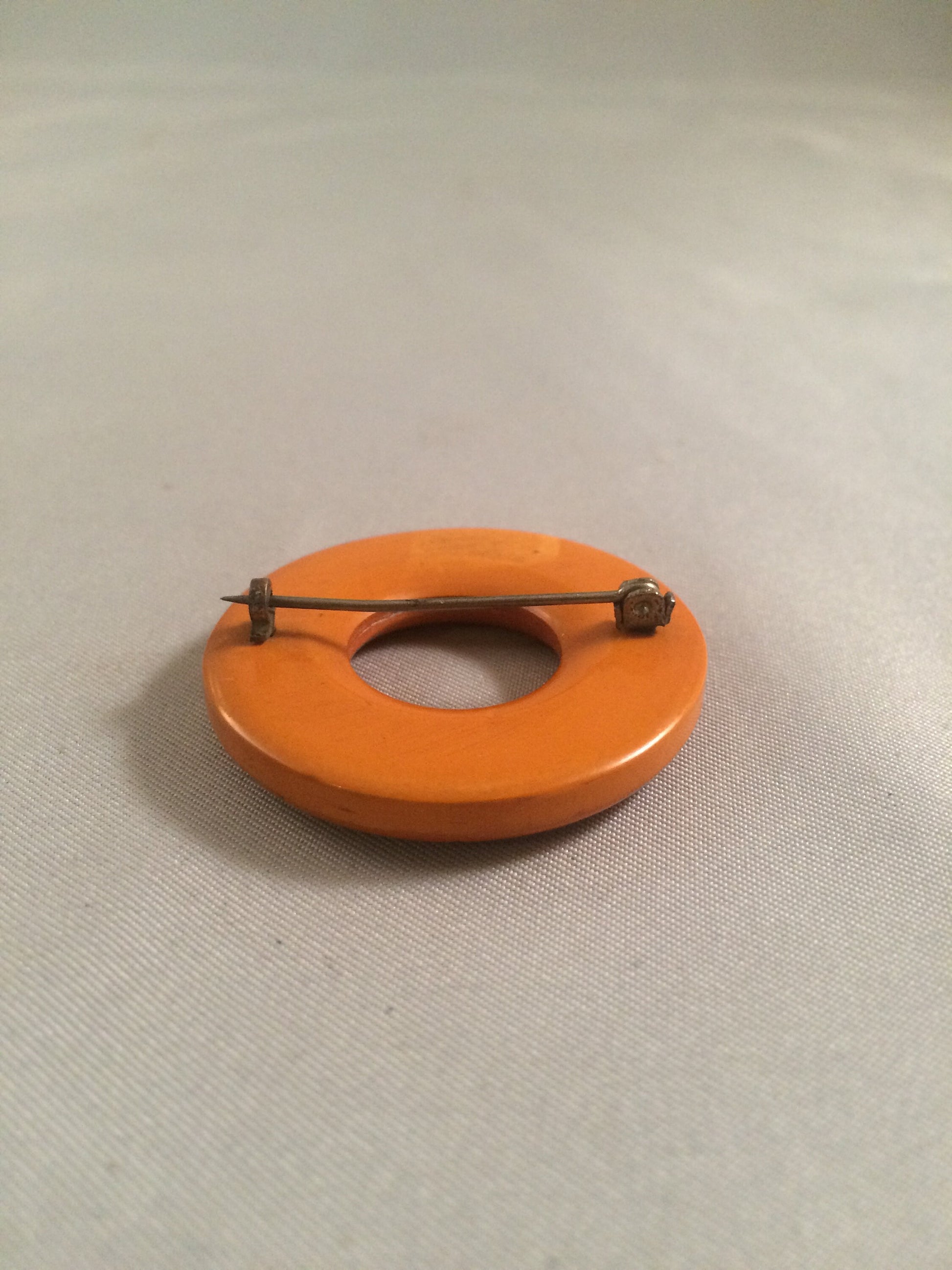 Bakelite Catalin Orange Carved Circle Brooch