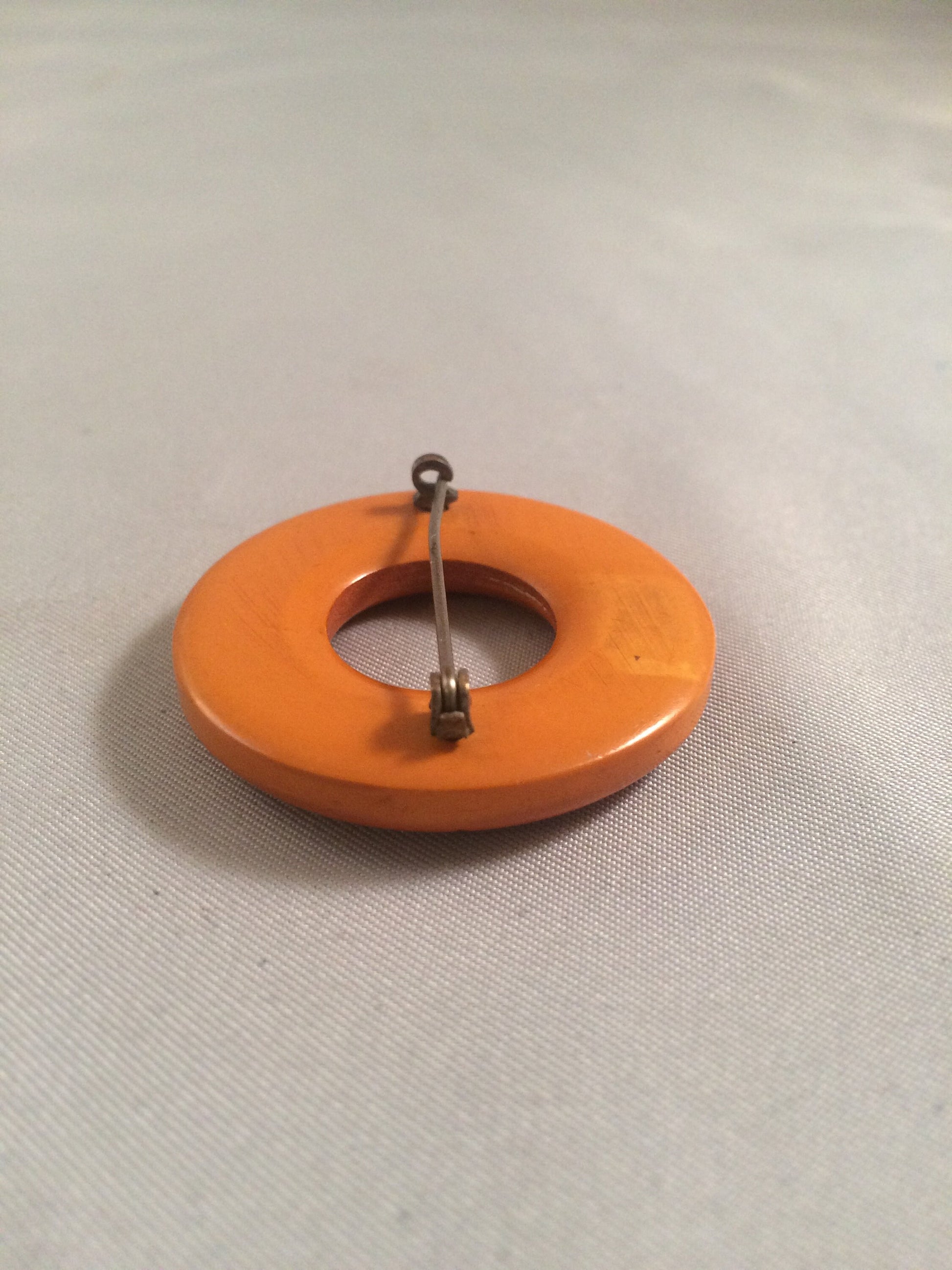 Bakelite Catalin Orange Carved Circle Brooch
