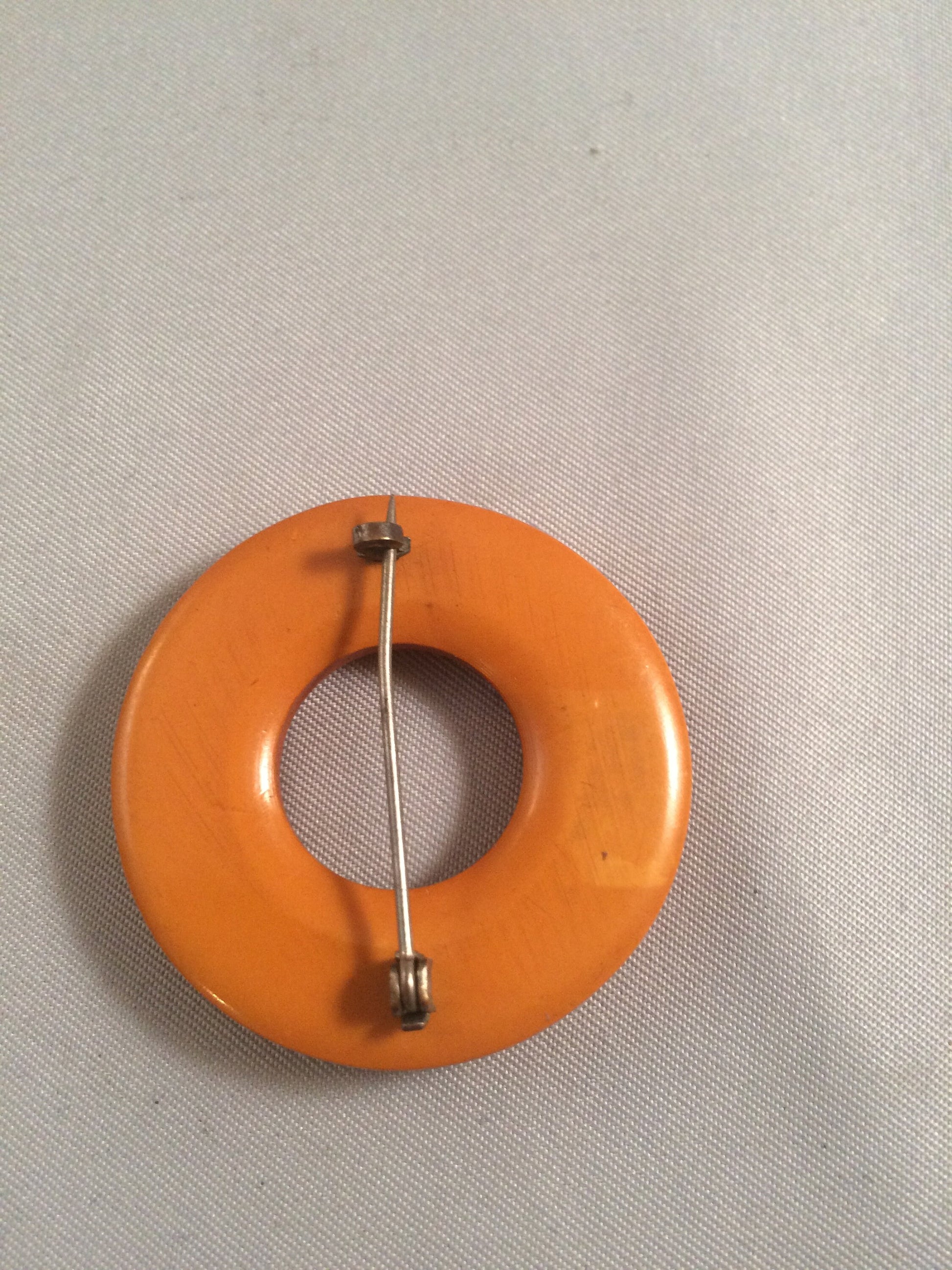 Bakelite Catalin Orange Carved Circle Brooch