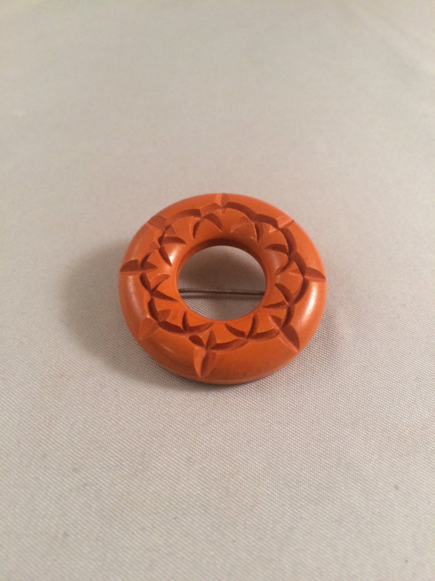 Bakelite Catalin Orange Carved Circle Brooch