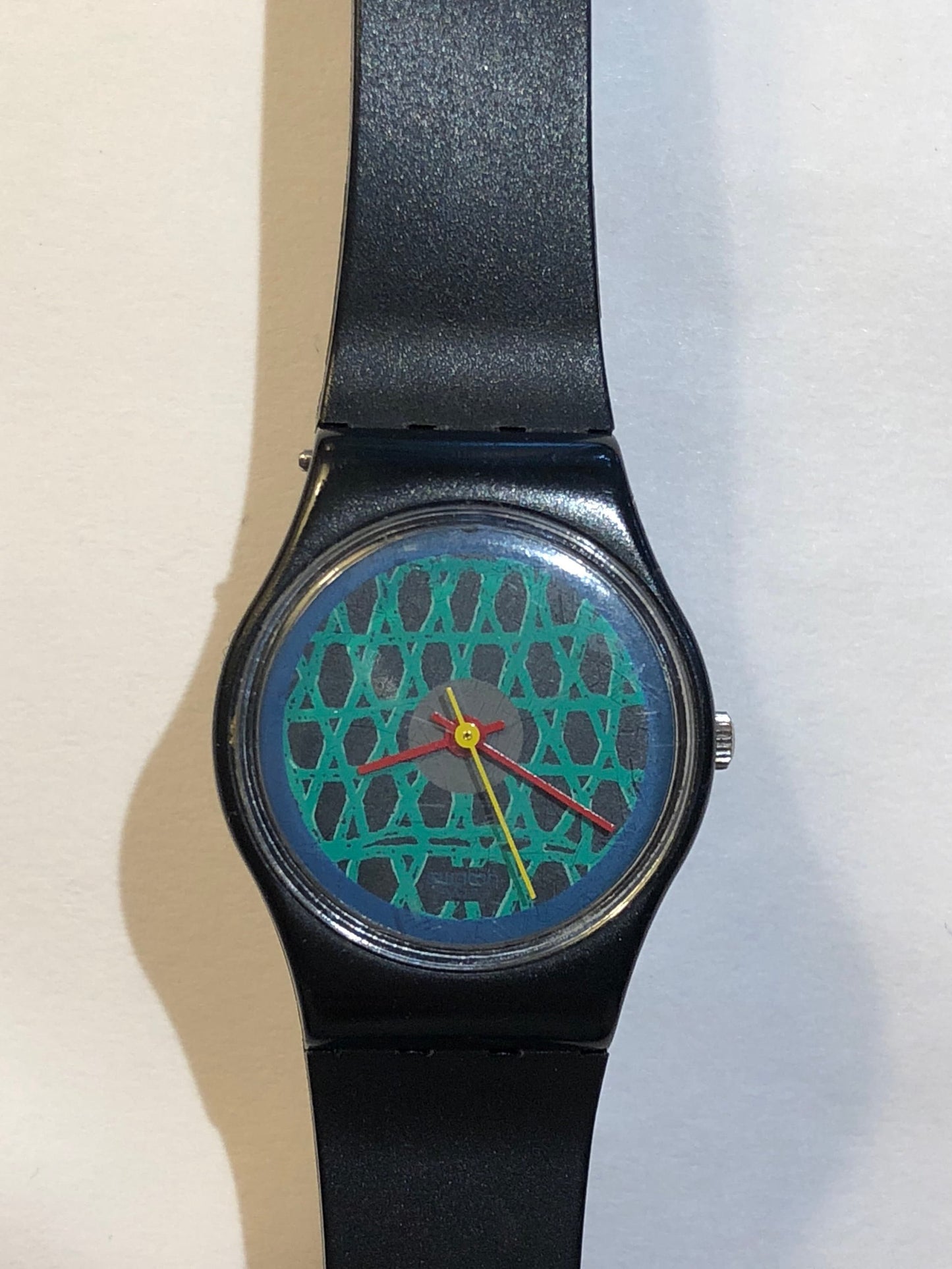 Vintage 1980s Swatch With A Green Net Design, Red & Yellow Minute/Hour hands.