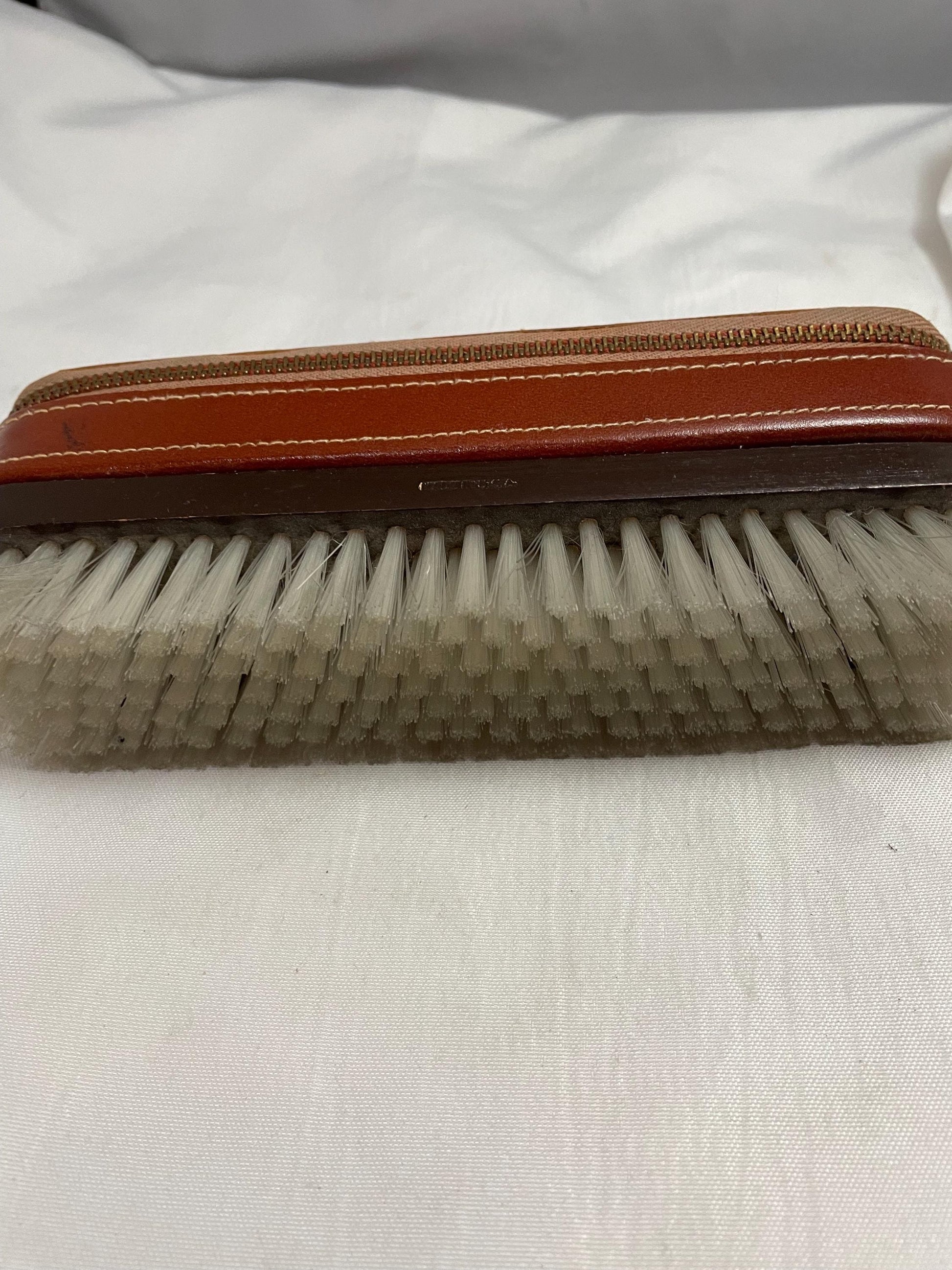 Vintage Theodore C. Salomon clothes/shoe brush W/ grooming accessories Leather zipped compartment.