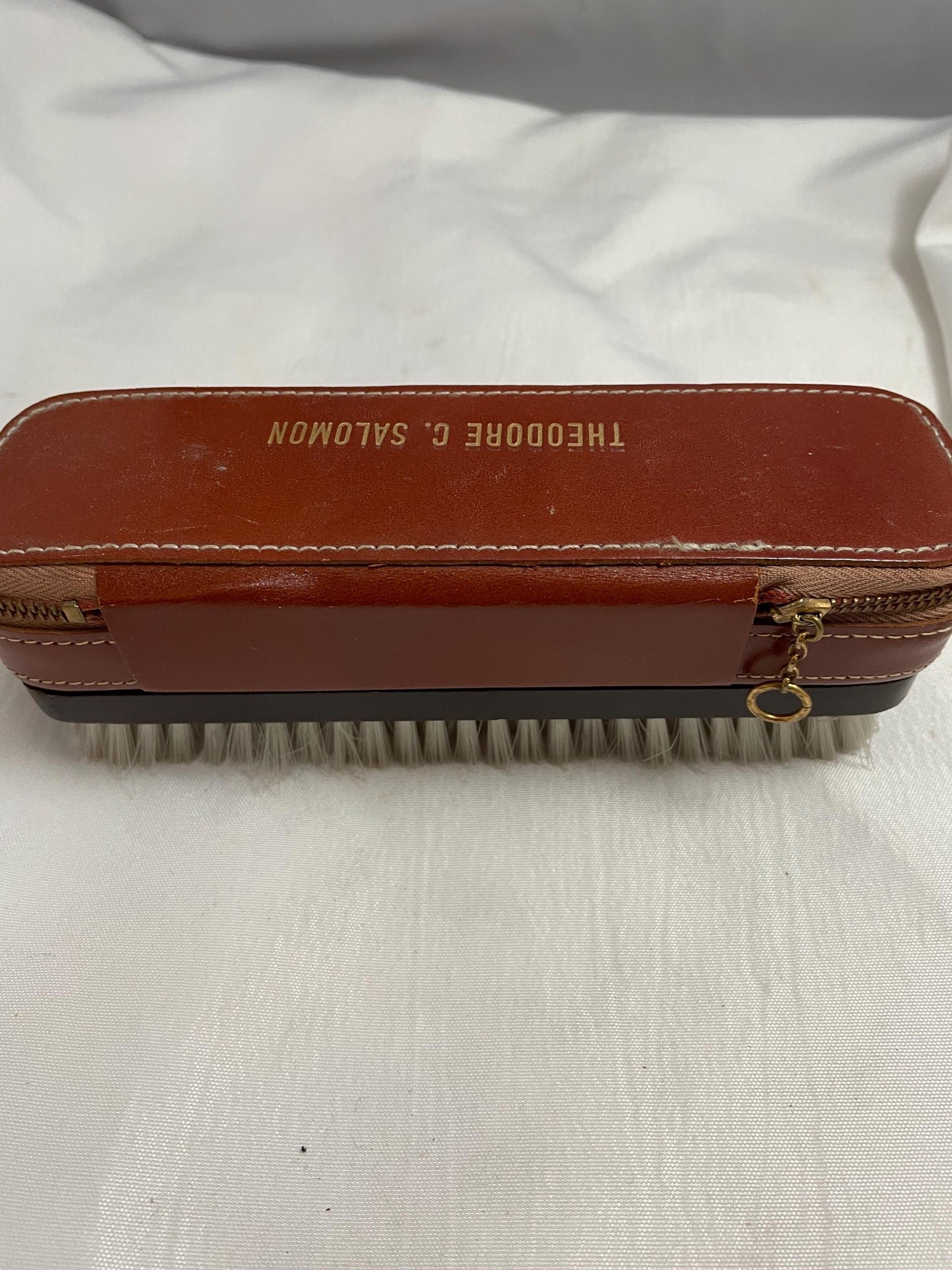 Vintage Theodore C. Salomon clothes/shoe brush W/ grooming accessories Leather zipped compartment.