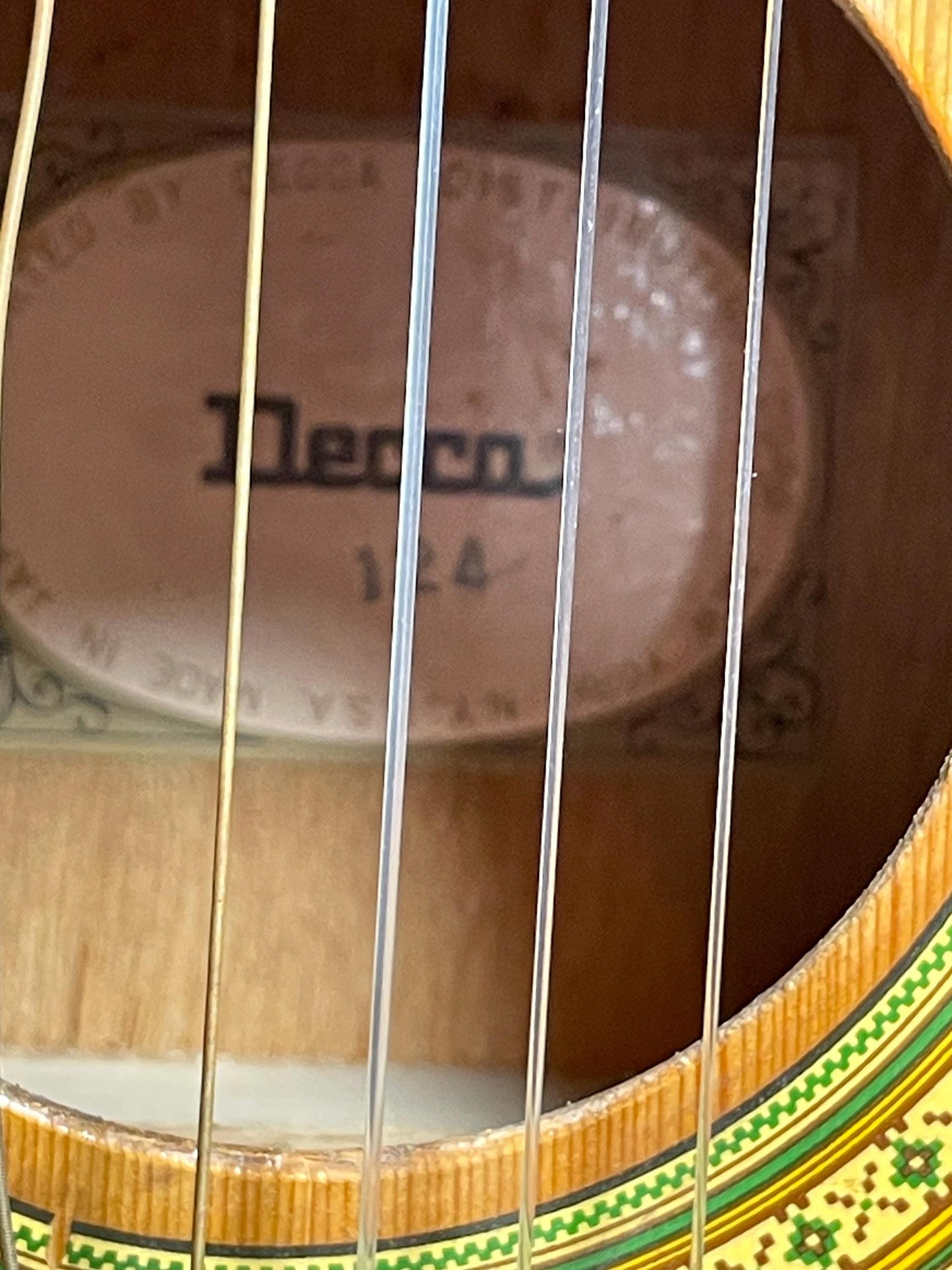 Decca Acoustic 124 Guitar w/ case. Back wood at bottom is cracked.