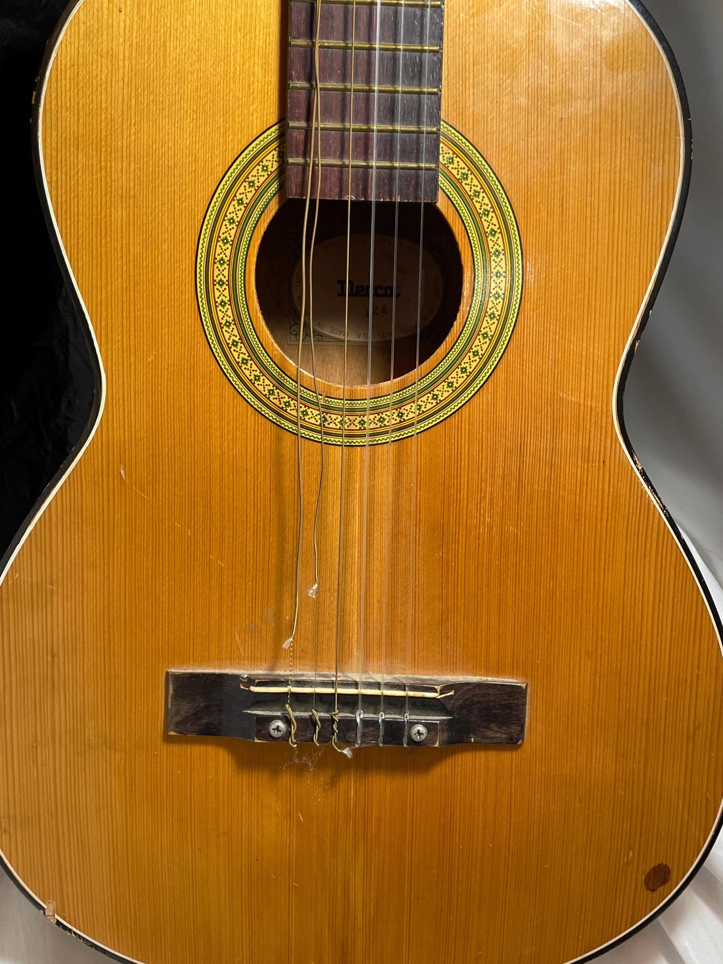 Decca Acoustic 124 Guitar w/ case. Back wood at bottom is cracked.