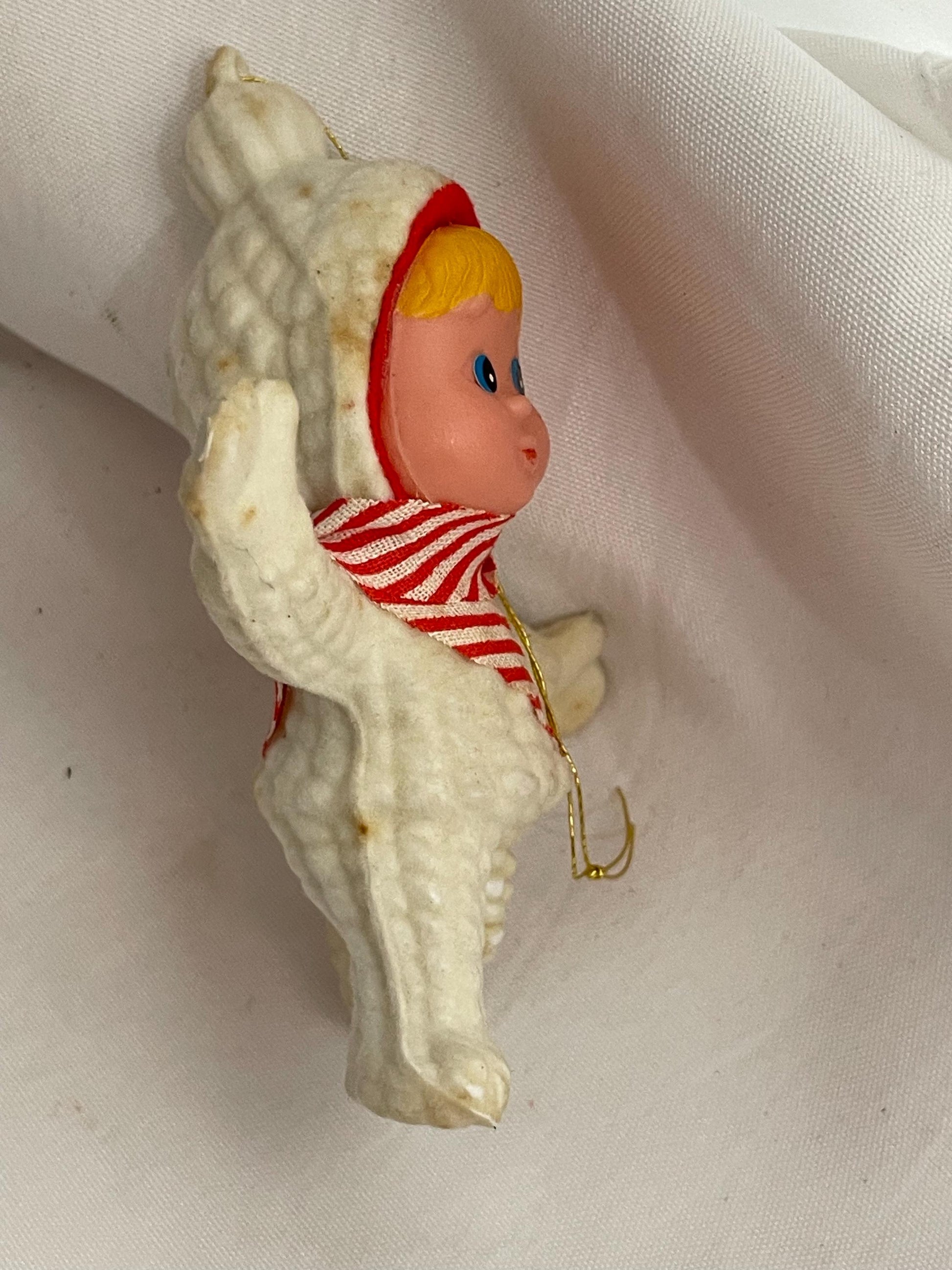 Vintage Flocked blonde hair and blue eyed girl in Snowsuit. ornament. needs white paint touch ups.