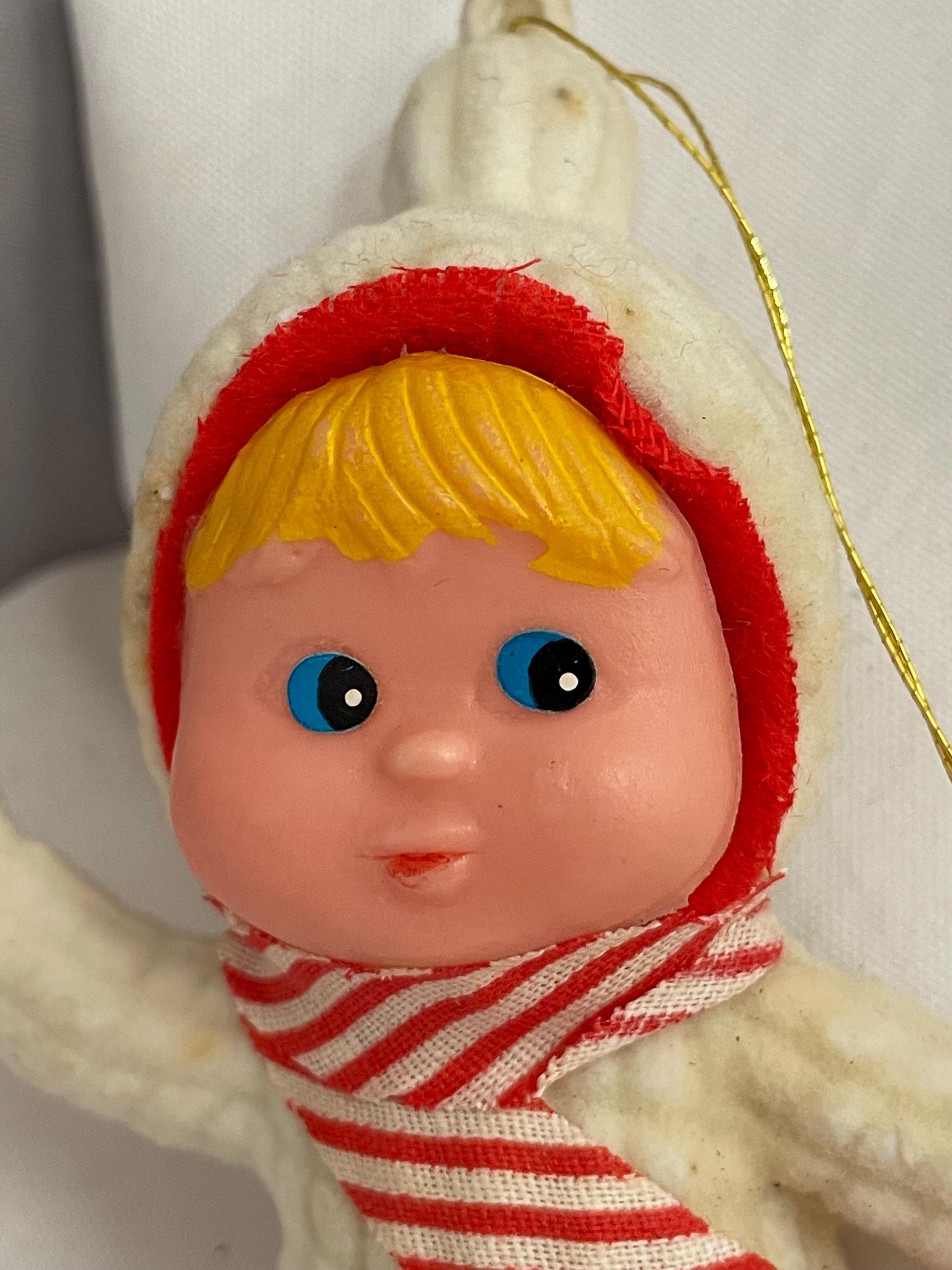 Vintage Flocked blonde hair and blue eyed girl in Snowsuit. ornament. needs white paint touch ups.