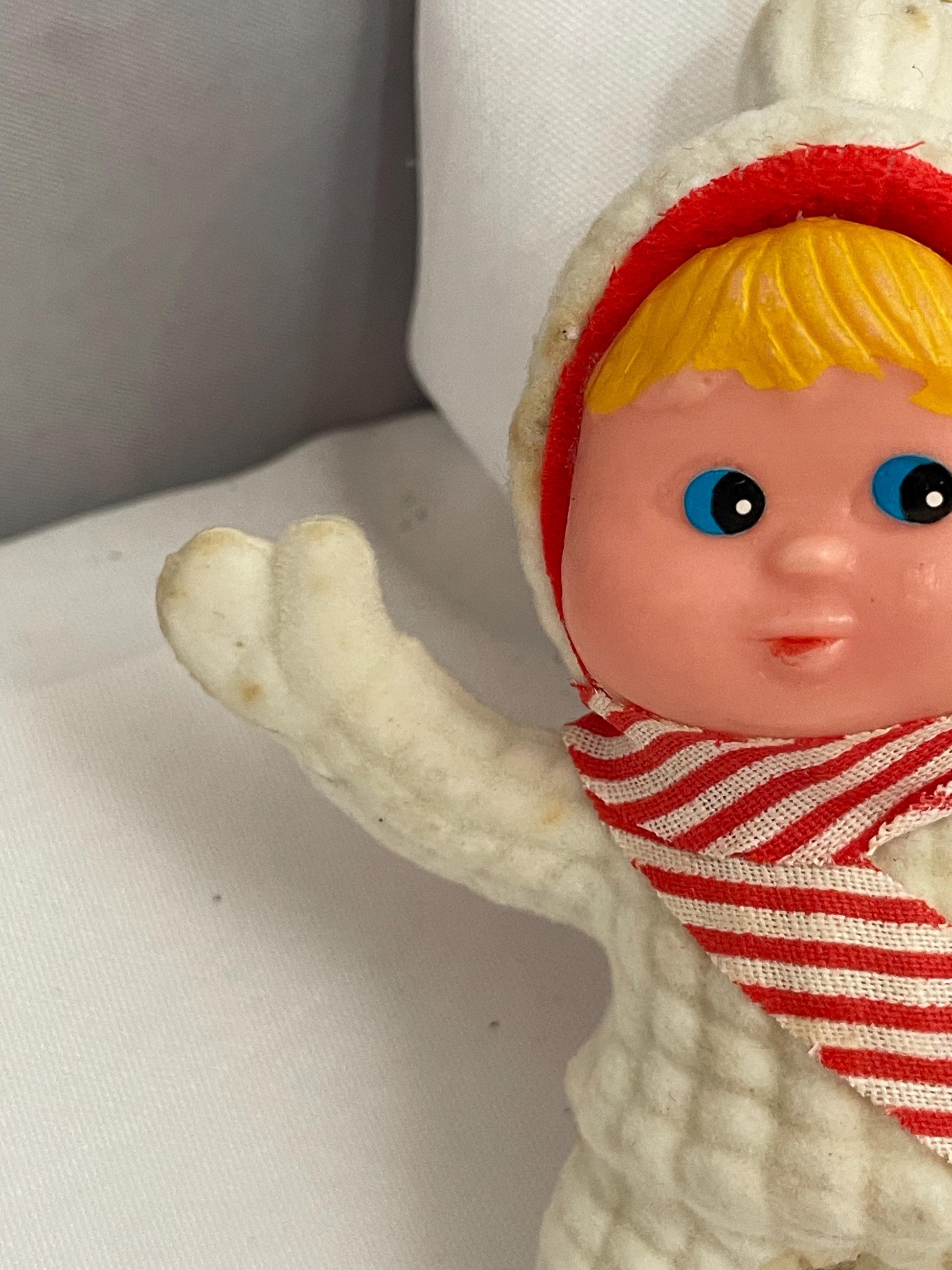 Vintage Flocked blonde hair and blue eyed girl in Snowsuit. ornament. needs white paint touch ups.