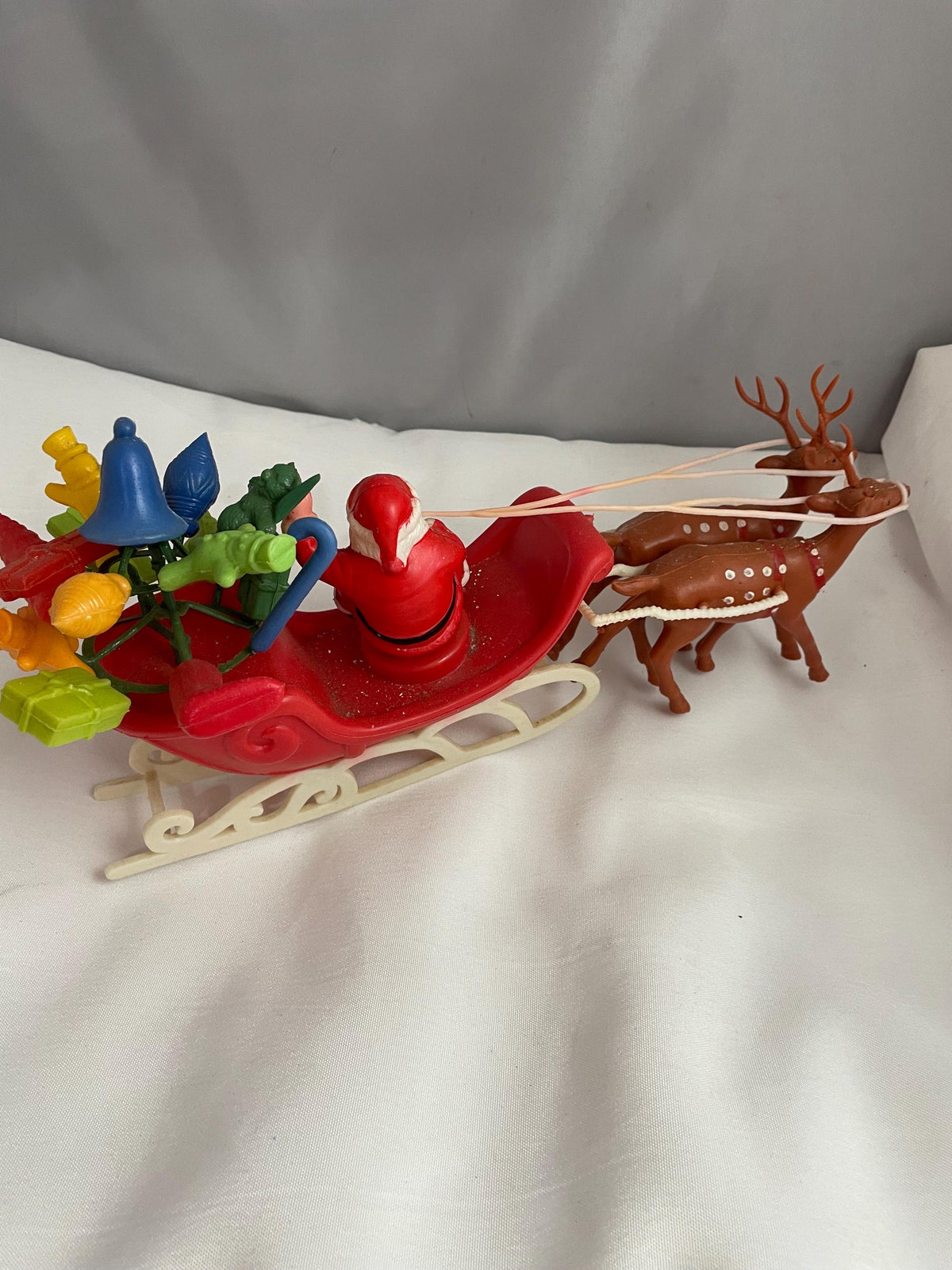 Vintage Plastic Santa claus With sled full of presents and his Reindeer Christmas decor.