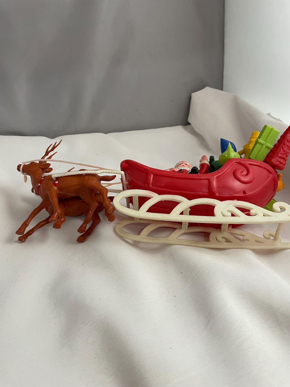 Vintage Plastic Santa claus With sled full of presents and his Reindeer Christmas decor.