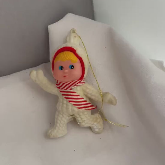 Vintage Flocked blonde hair and blue eyed girl in Snowsuit. ornament. needs white paint touch ups.