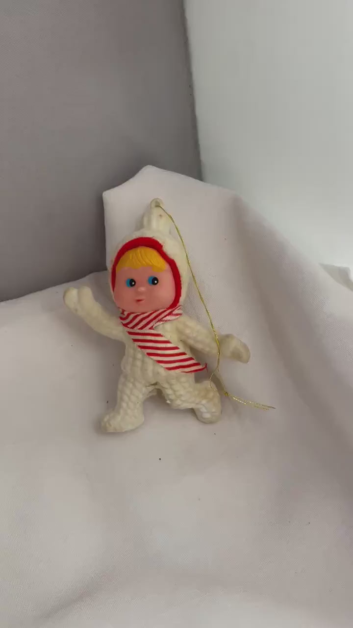 Vintage Flocked blonde hair and blue eyed girl in Snowsuit. ornament. needs white paint touch ups.